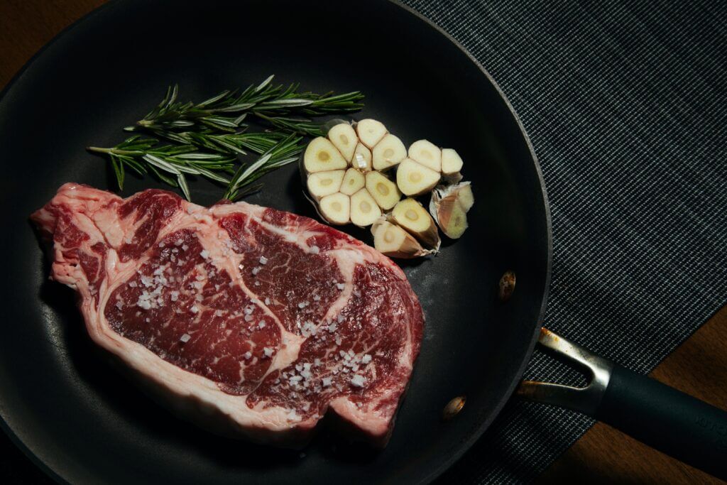 beef steak in frying pan